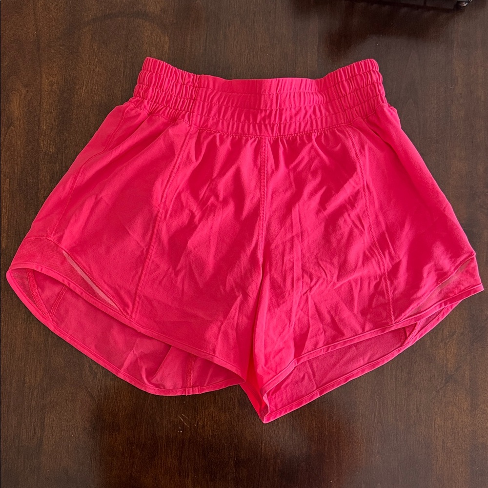 Size 2 Lululemon 4” Hotty Hot shorts. Vibrant Pink/coral colored Athletic Shorts